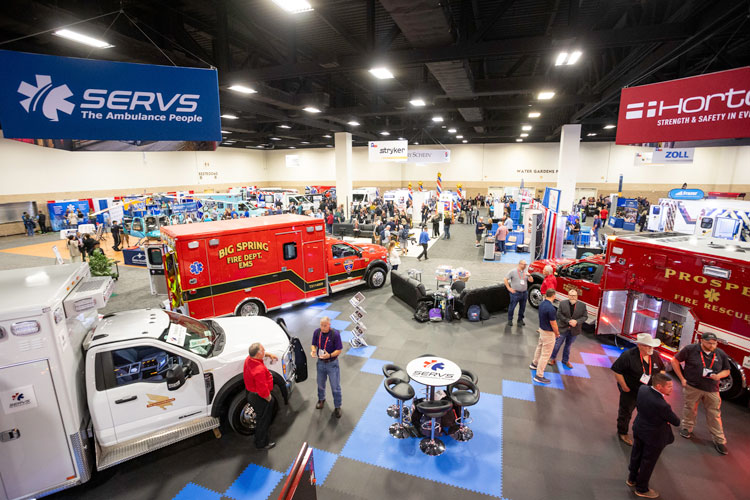 Exhibitors interacting with attendees in a large crowded exhibit hall | Texas EMS Conference